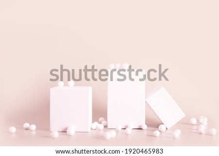White empty stands on light beige color background. Blank podiums shopfront decorated bubbles. Showcase for cosmetic or beauty promotions. Product display advertisement. Copy space.