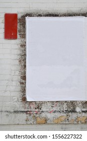 White Empty Weathered Street Poster Glued On Urban Worn Exposed Brick Wall