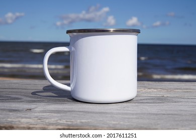 White Enamel Mug Mockup For Design Presentation, Close Up Blank Camping Cup On Outdoor Camping, The Sea On Background.