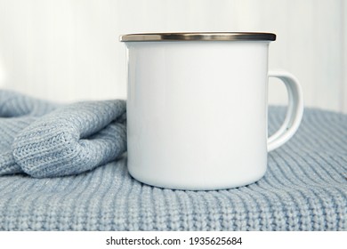 White Enamel Travel, Camping Mug Mockup For Design, Warm Blue Sweater.       