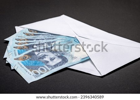 White envelope full of 100 peruvian soles bills on a white background
