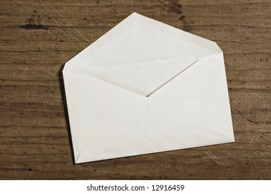 White Envelope On Wooden Table, Open, Studio Shot.