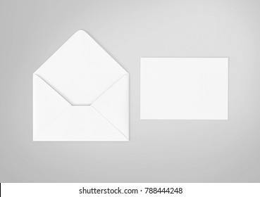 White envelope and post card on the white background, top view.