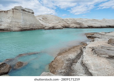 White eroded cliffs around calm turquoise cove in a Greek island.
A calm turquoise coastal cove is surrounded by smooth white eroded cliffs revealing the beauty of nature.