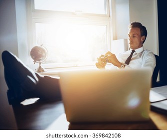 White executive business man sitting at his desk getting inspiration and thinking