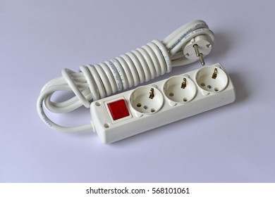 White extension cable with three plug socket and red switch - Shutterstock ID 568101061
