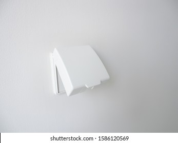 White External Waterproof Cover Plug For Use Outdoor Area On White Wall Background, Double Electrical Plug Socket, Electric Safety Concept.