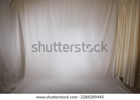 White fabric background and light curtains. Location, frame for shooting in photo studio. Theater stage for backstage performances