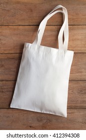 White Fabric Bag On Wooden Table 