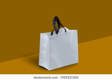 White Fabric Non Woven Box Bag Mockup On Dark Yellow Background. Copy Space For Text And Logo. Eco Friendly Concept. White Shopping Grocery Shopper Isolated Yellow Background. Empty Kraft Bag
