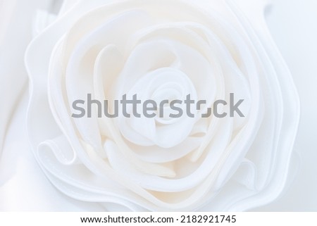 White fabric rose, Details of the bride dress and beautiful embroidery wedding concept used as a background for illustration.