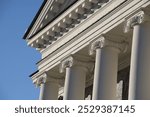 White facade with columns against the sky