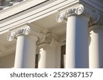 White facade with columns against the sky