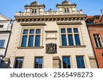 White facade of the House of furrier Miks (in Czech "Mikšův dům"), a Neo-Renaissance style townhouse part of the Old Town Hall complex, in Old Town Square, Prague, Czechia