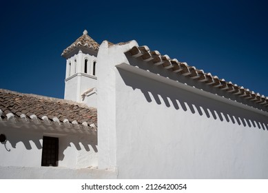 White Facade And Roof Overhang With Shadows