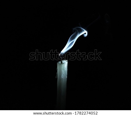 White fade candle smoke on dark black background