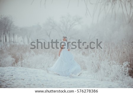 White fairytale princess in frozen world. Vintage wedding dress. Winter fantasy.