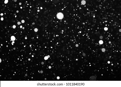 White Falling Snow Against The Black Sky. Snow Blizzard On A Black Background. Isolated