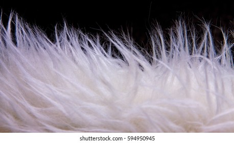 White Faux Fur On Black Background, Soft Focus.