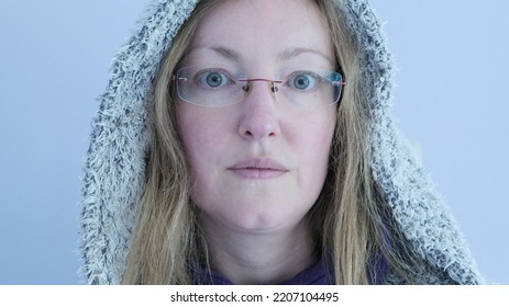 White Female With A Hoodie, Green Eyes And Blond Hair In A Cold Atmosphere