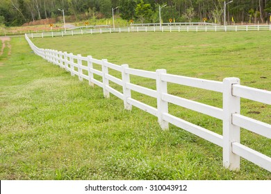 White Fence In Farm Field