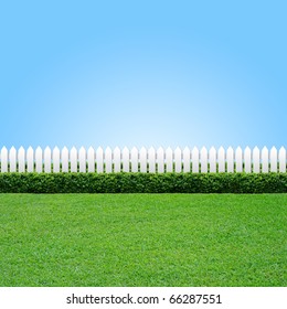 White fence and green grass on blue sky - Shutterstock ID 66287551