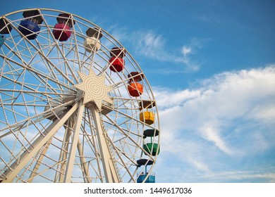 White ferris wheel at an amusement park.
