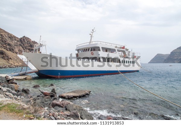 White ferryboat for car and people in port of\
island Terasia,  Santorini ,\
Greece\
