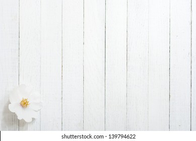 white field rose flower on bright wooden surface - Powered by Shutterstock