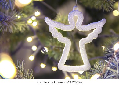 White Figure Of A Christmas Angel On A Tree