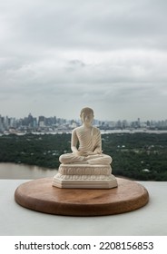 White figurine of siddhartha gautama buddha sculpture statue with nature background. Space for text, Selective focus.