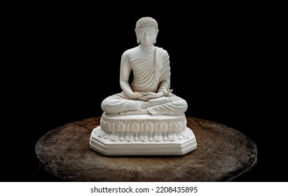White figurine of siddhartha gautama buddha sculpture statue with dark background. Space for text, Selective focus.