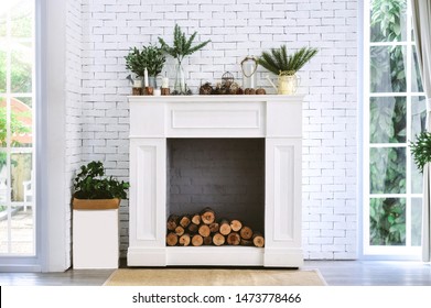 White Fireplace With Old Wooden In Room And Decoration.