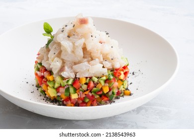 White Fish Ceviche Served On Kiwi, Persimmon, Avocado, Cucumber and Red Pepper Salad