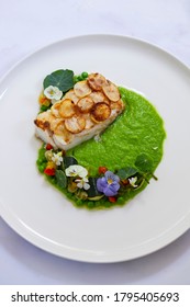 White Fish Fillet With Potato Scale, Pea Puree And Summer Vegetable