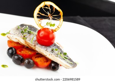 White Fish Steak And Tomatoes In A Plate. Selective Focus.