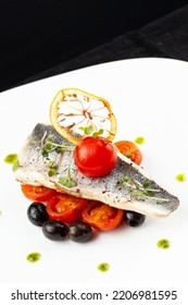 White Fish Steak And Tomatoes In A Plate. Selective Focus.