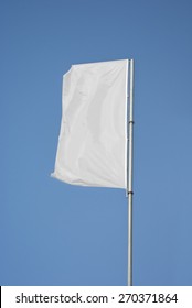 White flag flying on blue sky