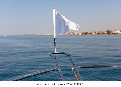 White Flag Waving On The Bow Of A Boat