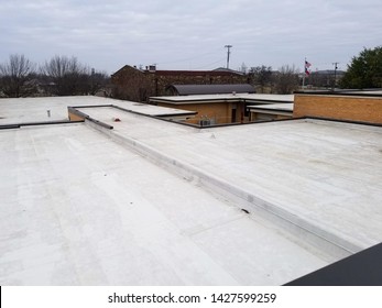 White flat tarp roof of commercial building
