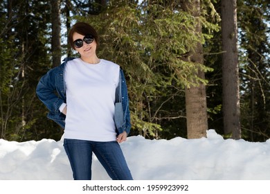 White Fleece Crewneck Sweatshirt Mockup Featuring A Woman Wearing Sunglasses By A Snowy Woods. Heavyweight Sweatshirt Template, Model Mockup  