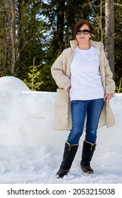 White Fleece Crewneck Sweatshirt Mockup Featuring A Woman Wearing Beige Quilted Coat And Black Snow Boots. Heavyweight Sweatshirt Template 