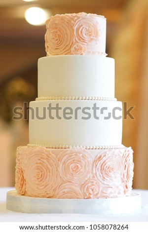 white floral wedding cake on restaurant interior background