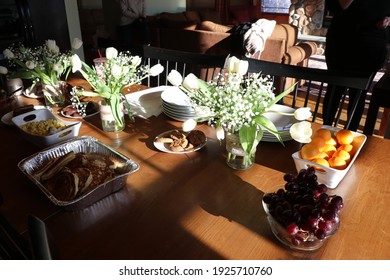 white flower bouquet at breakfast table sunlight shining on white tulips and baby breath flowers in rustic vase with morning coffee fruit dishes breakfast rustic kitchen meal with food and flowers sun - Shutterstock ID 1925710760