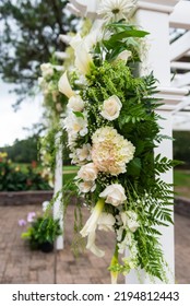 White Flowers With Green Leaves Hung On A White Wedding Arbor Isolated