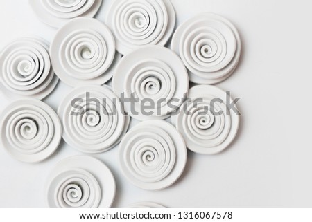 white flowers made from a spiral cut out of rubber eva or foamy. Crafts for spring. Mother's Day. Women's Day. March 8 Craft gift. Stamping roses.