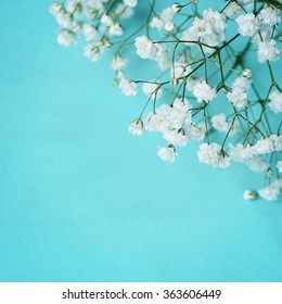 White flowers on blue textile background