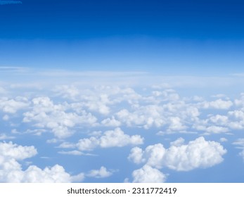 White fluffy clouds in blue sky, top view. View from flying airplane window, climate concept. Beauty soft cloud texture
 - Shutterstock ID 2311772419