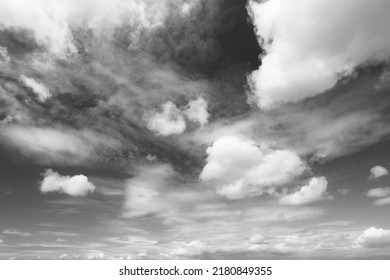White fluffy clouds on blue sky. Idyllic background abstract. Photo in black and white.