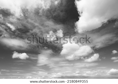 White fluffy clouds on blue sky. Idyllic background abstract. Photo in black and white.
